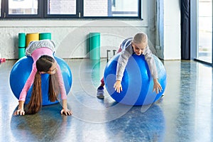 two joyful girls in sportswear lying