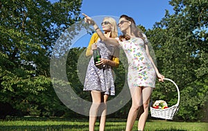 Two joyful ladies wearing trendy wooden sunglasses