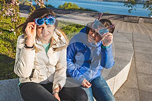 Two joyful women in funny sunglasses