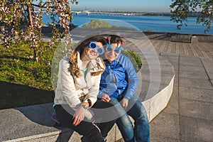 Two joyful women in funny sunglasses