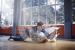 Two judo fighters showing technical skill while practicing martial arts in a fight club