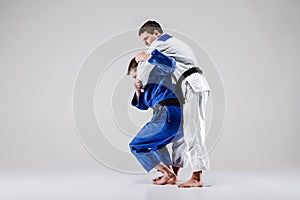 The two judokas fighters fighting men