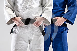 The two judokas fighters posing at studio