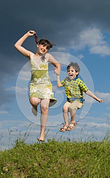 Two jumping children - brother and sister