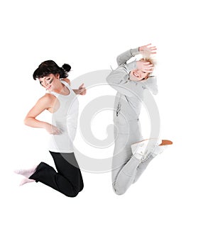 Two jumping fitness instructors isolated on white