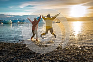 Two jumping girls in ice lagoon