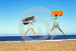 Two jumping kids excitement on the Atlantic ocean summer beach