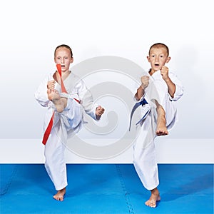 Two karateka in karategi are beating kick leg forward