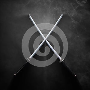 Two katanas with crossed blades in dramatic smoke