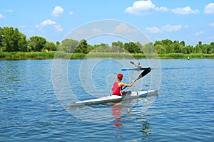 Two kayakers, boy and girl, meet on river