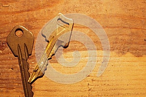 Two keys isolated on a wooden background. safety and security concept
