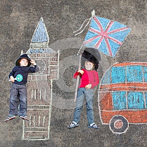 Two kid boys in british soldier policeman uniform with London pi