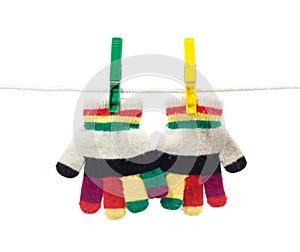 Two kid gloves on clothes line