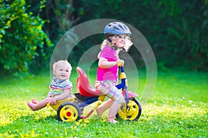 Two kids on a bike photo