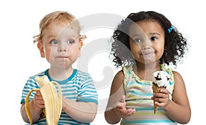 Two kids boy and girl eading fruit and ice cream