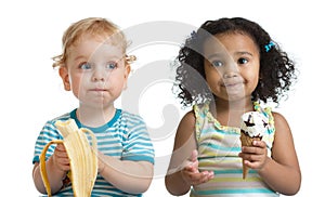 Two kids boy and girl eading fruit and ice cream photo