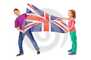 Two kids, boy and girl waving English flag
