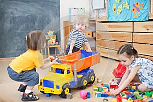 Two kids conflict or struggling for toy truck in kindergarten