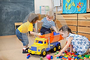 Two kids conflict for toy truck in kindergarten