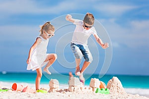 Two kids crushing sandcastle