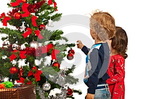 Two kids decorate Christmas tree