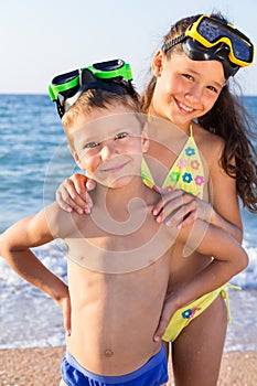 Two kids in diving masks on the sea