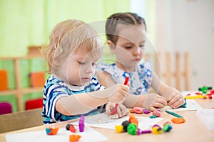 Two kids doing arts and crafts in day care centre
