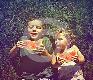 Two kids eating watermelon done with a retro vintage instagram f