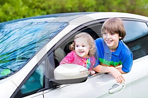 Two kids enjoy vacation car ride on summer weekend