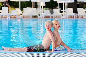 Two kids having fun in summer swimming pool
