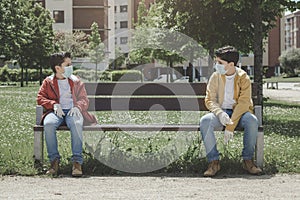 Two kids with medical mask maintain social distancing