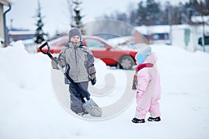 Two kids outdoors at snowy winter day