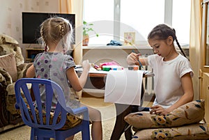 Two kids painting at home