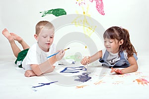Two kids are painting pictures.