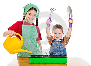 Two kids planting the seedling