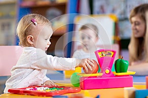 Two kids play role game in toy shop at home or kindergarten