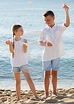 Two kids playing paper planes