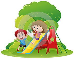 Two kids playing slide in the park