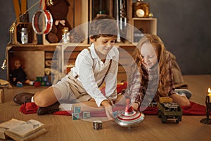 Two Kids Playing With Toys Near the Christmas Tree