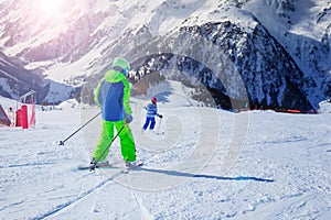 Two kids racing down the slope