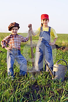 Two kids with shovel and can