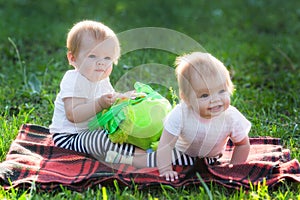 Two kids on a sunny summer day on lawn with a