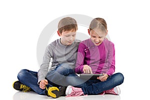 Two kids using digital tablet