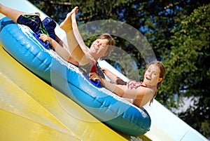 Two kids on water slide