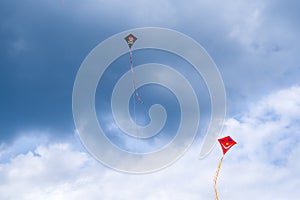 Two kites, symbolizing Good and Bad, flying in the sky