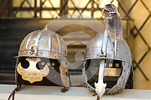 Two knight's helmets are lying on the surface.Medieval concept