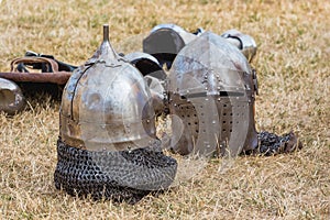 Two knightly helmets on the grass in the break between fights_ photo