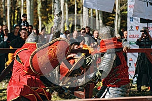 Two knights fight each other with swords. Festival of jousting tournaments.