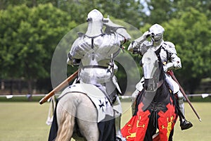 Two knights salute during medieval jousting tournament