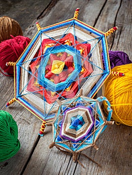 two knitted tibetan mandala from threads and yarn, selective focus